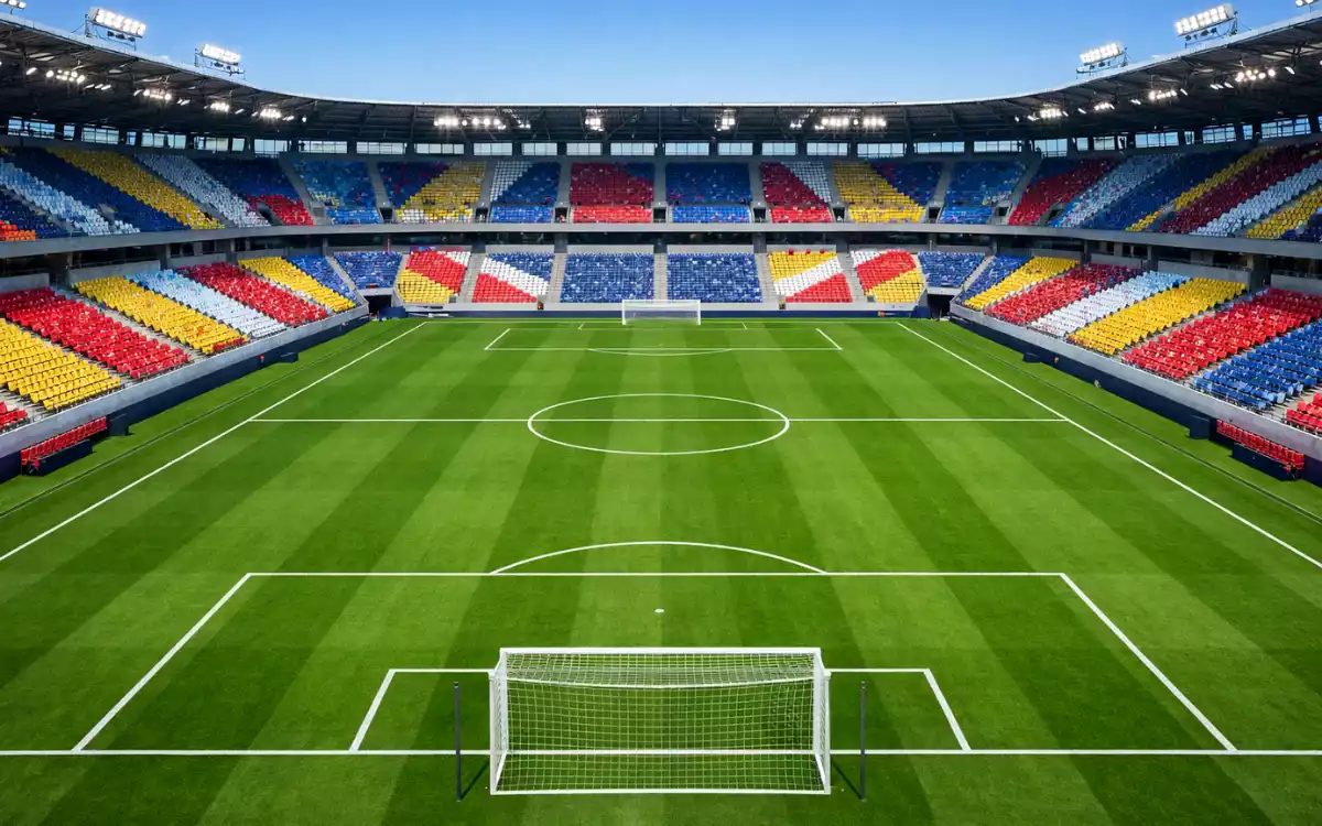 Vista aérea de un estadio de fútbol con campo verde perfectamente marcado